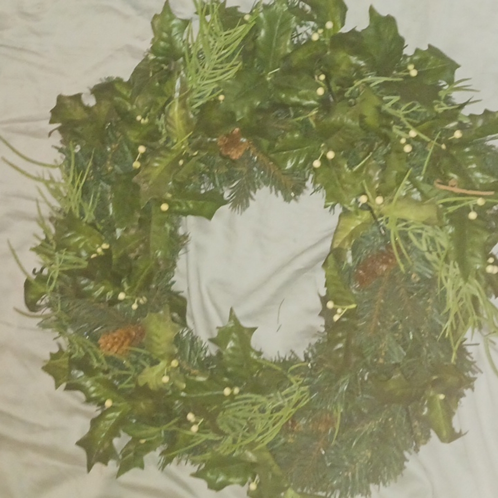 Medium wreath with pinecone leaves and white berries. Beautifully used.